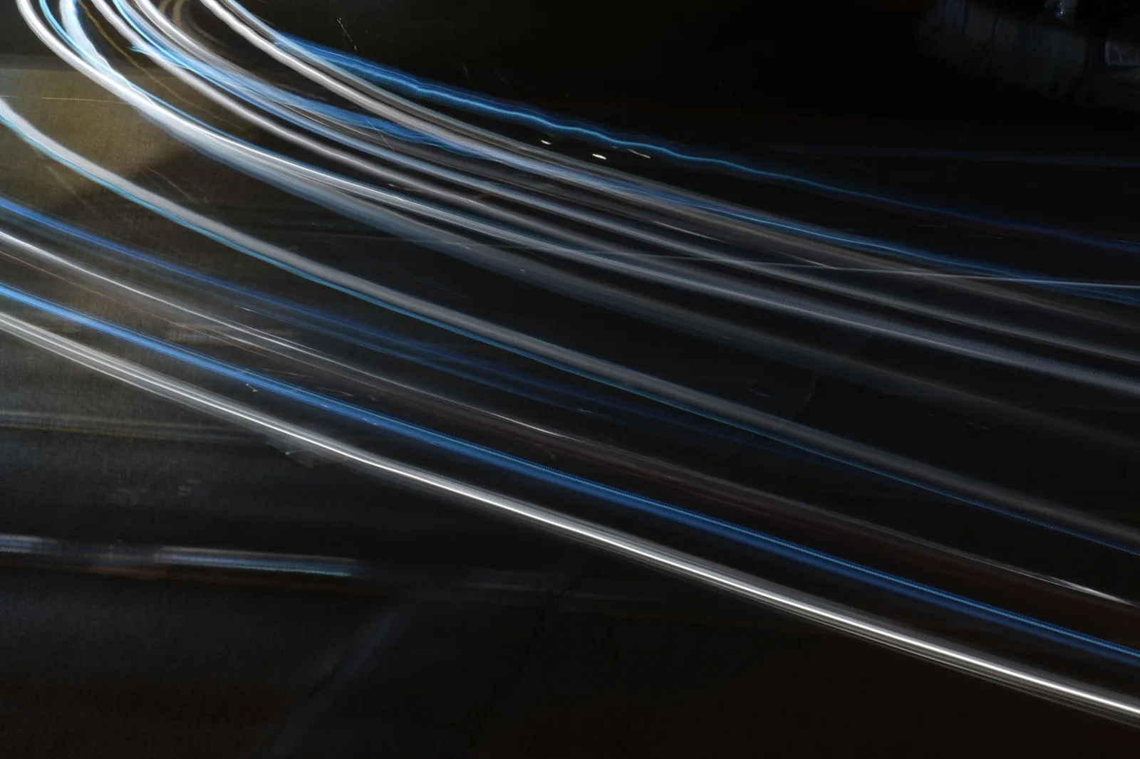 Abstract long exposure light trails captured at night, showcasing movement and dynamism.