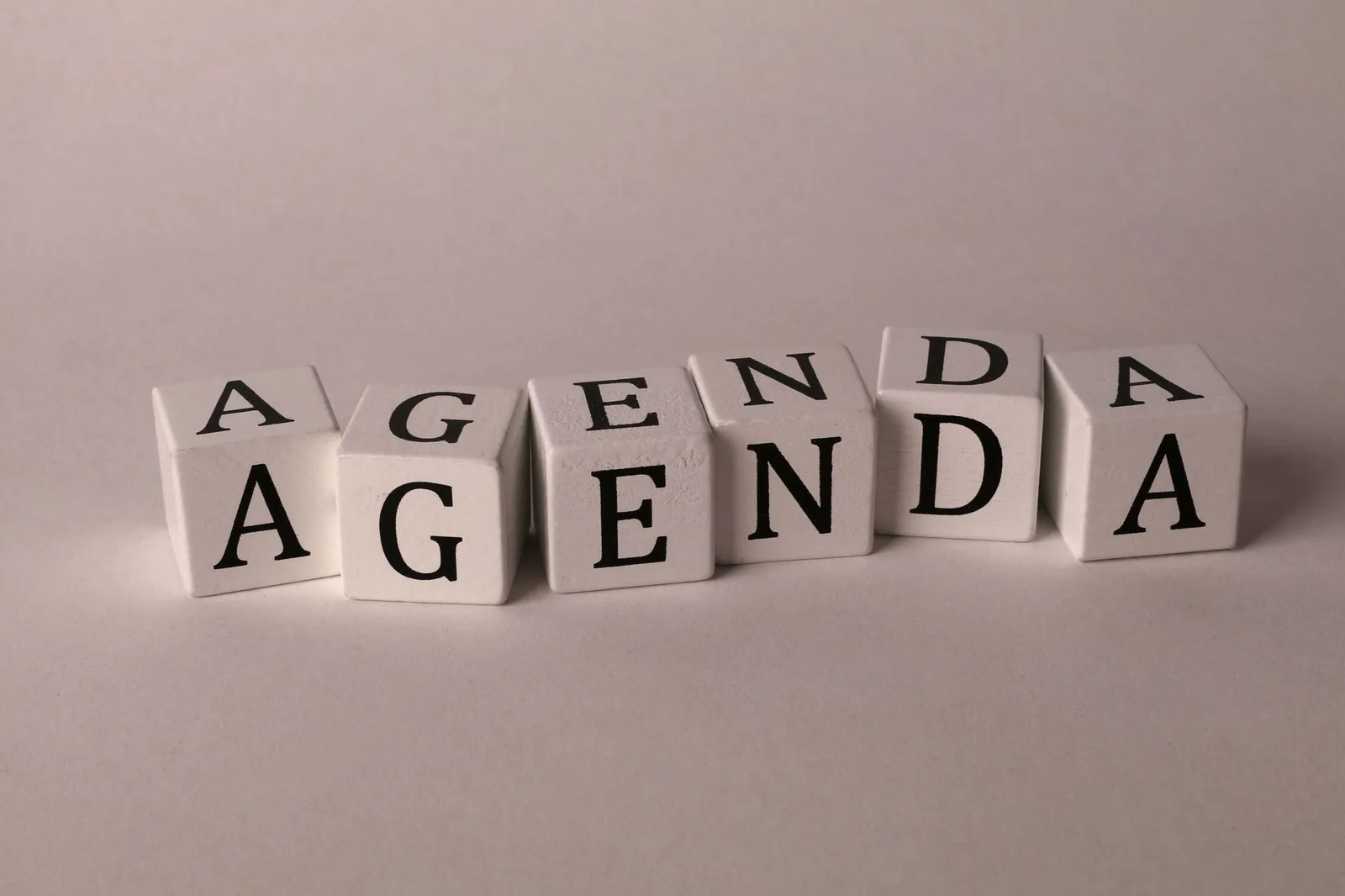 White cubes spelling 'AGENDA' symbolize business strategy and planning concepts.